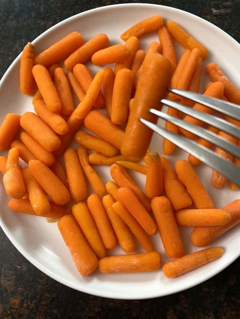 fork holding steamed carrot
