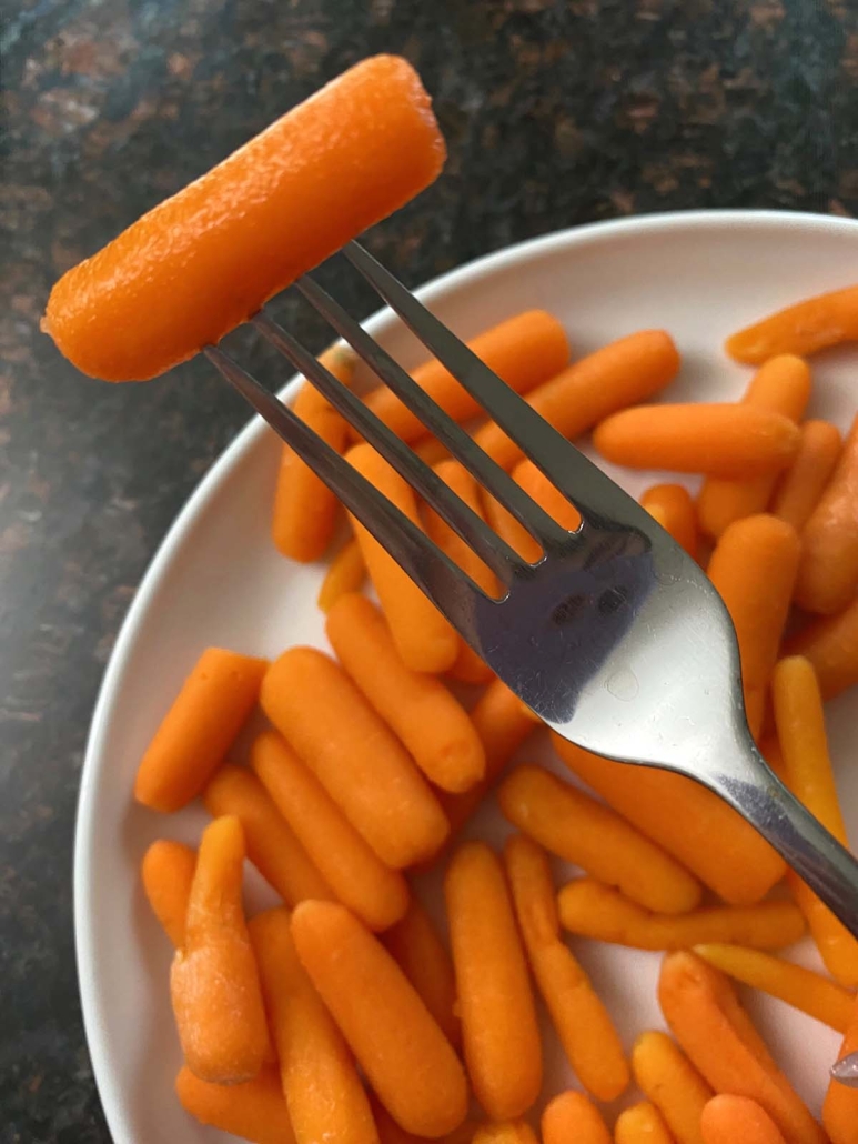 fork holding Microwave Steamed Baby Carrot