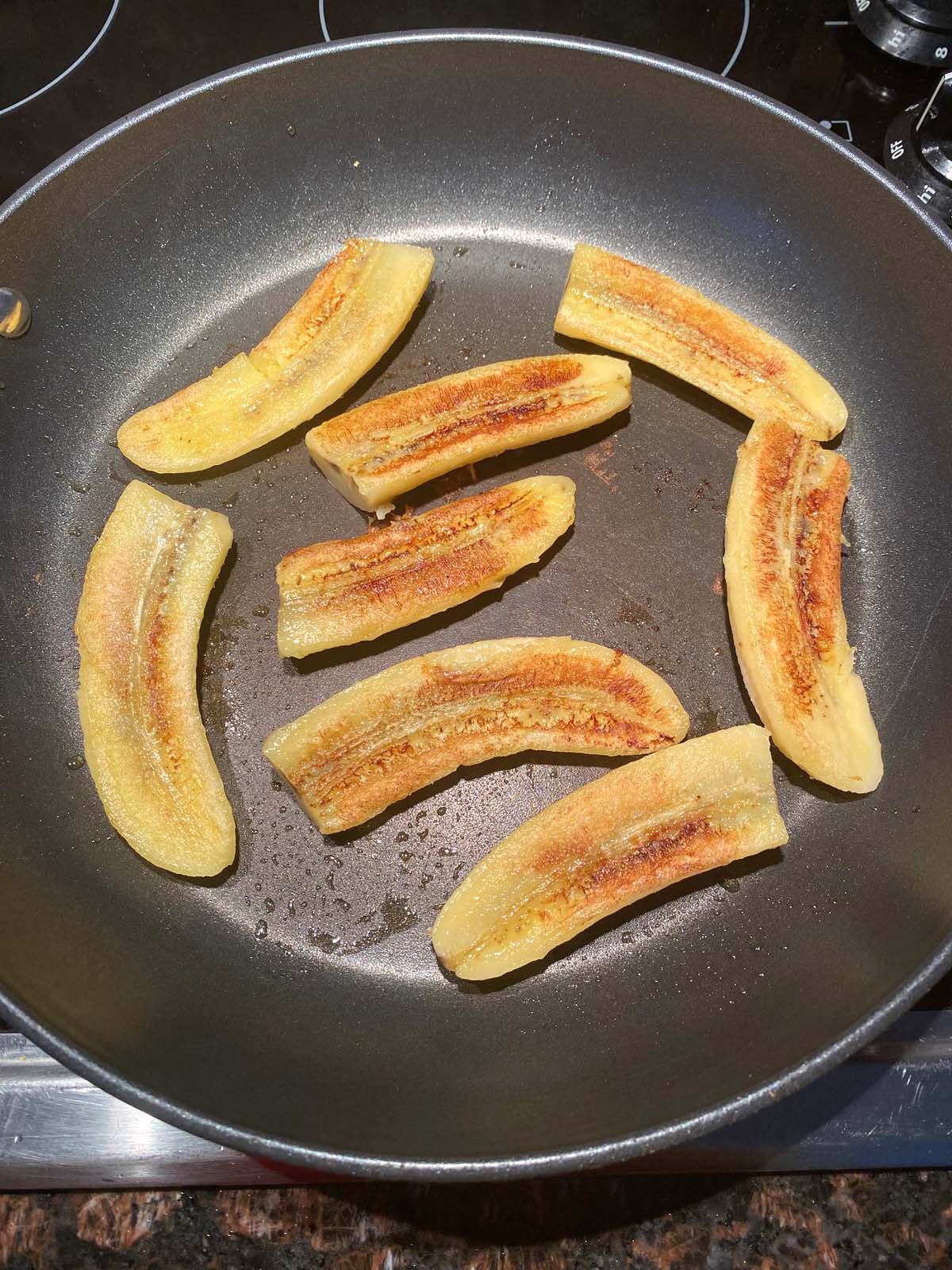 Fried bananas in a frying pan.