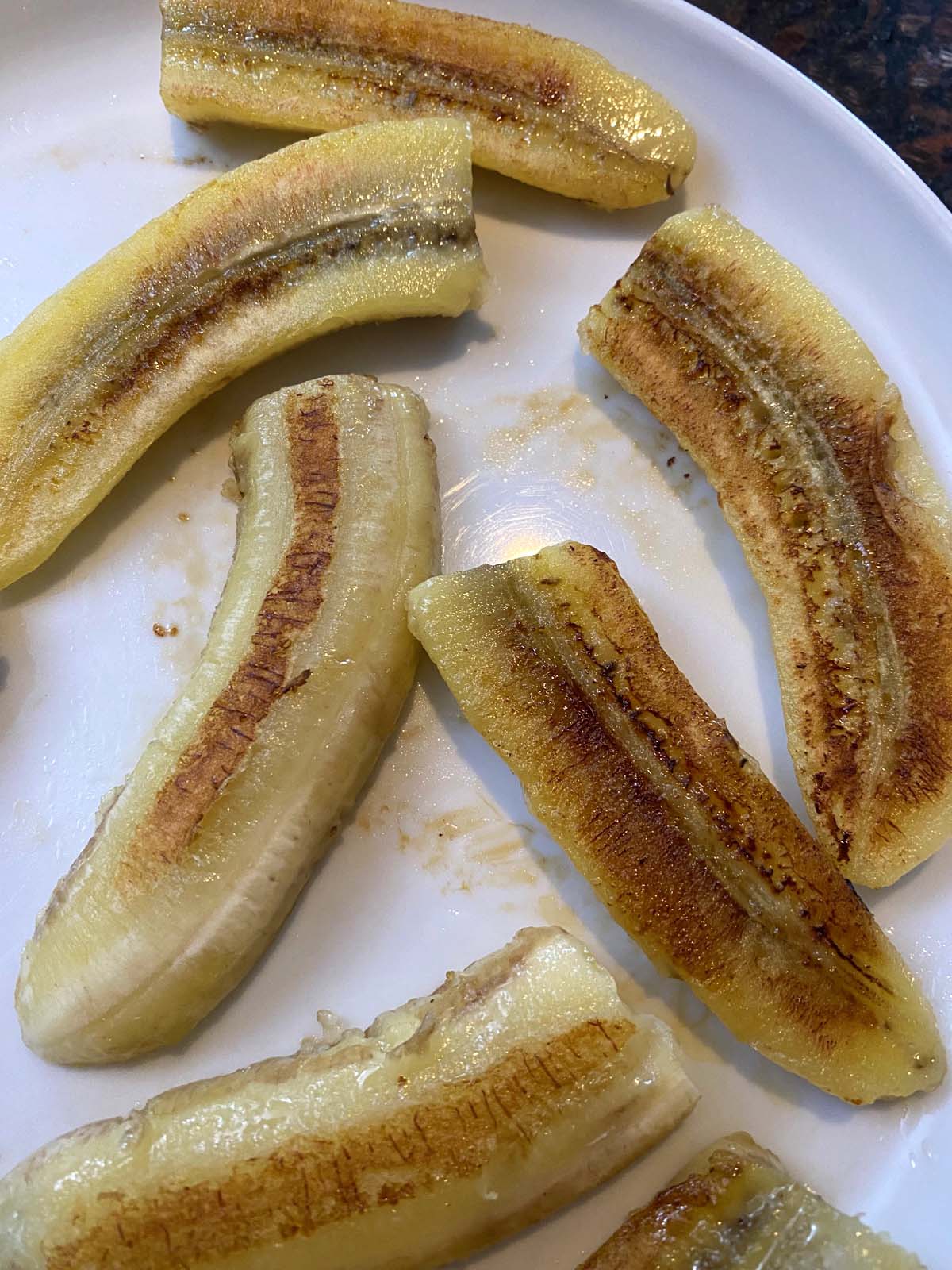 Fried bananas on a white plate.