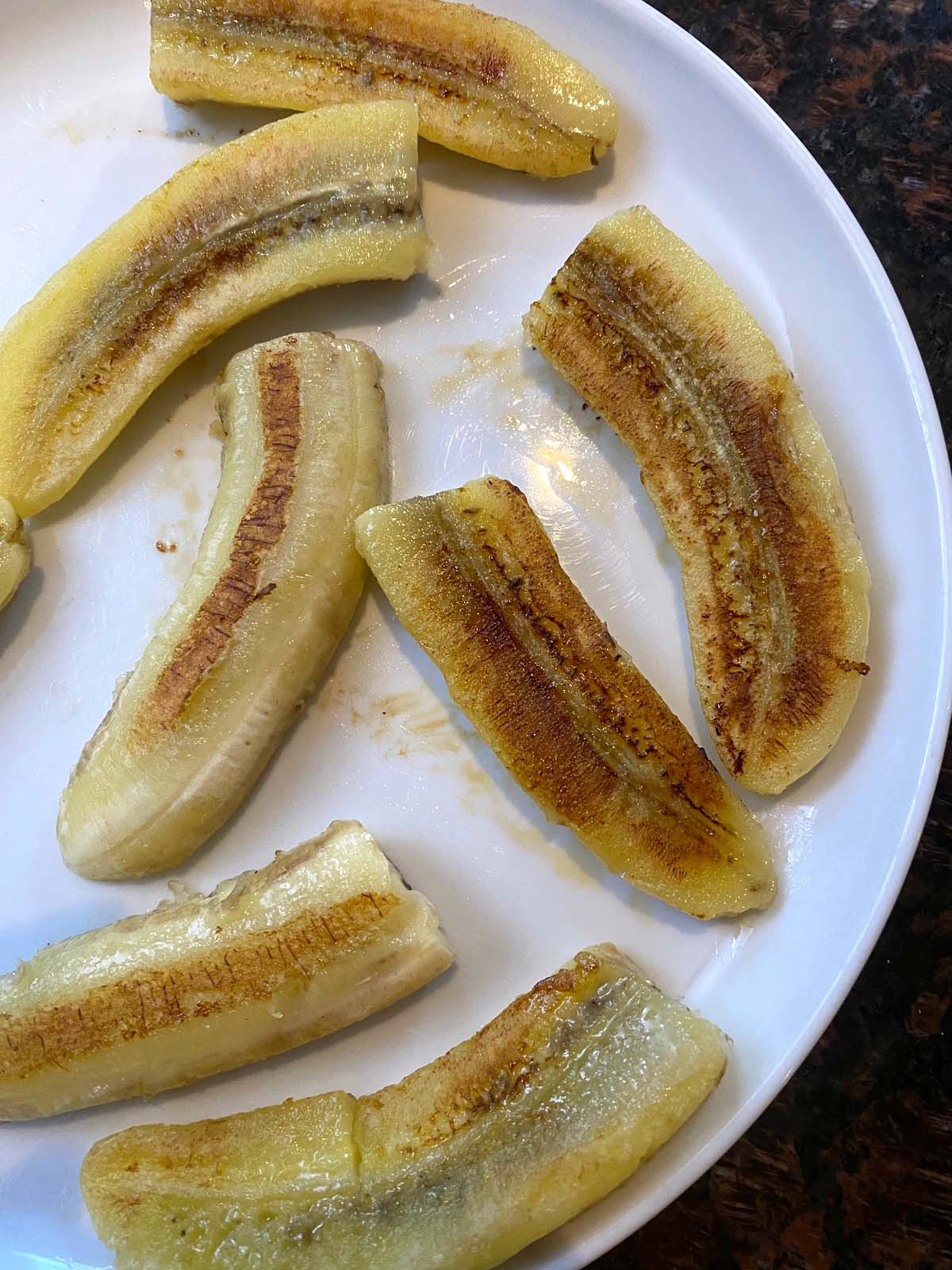 Fried bananas on a white plate.