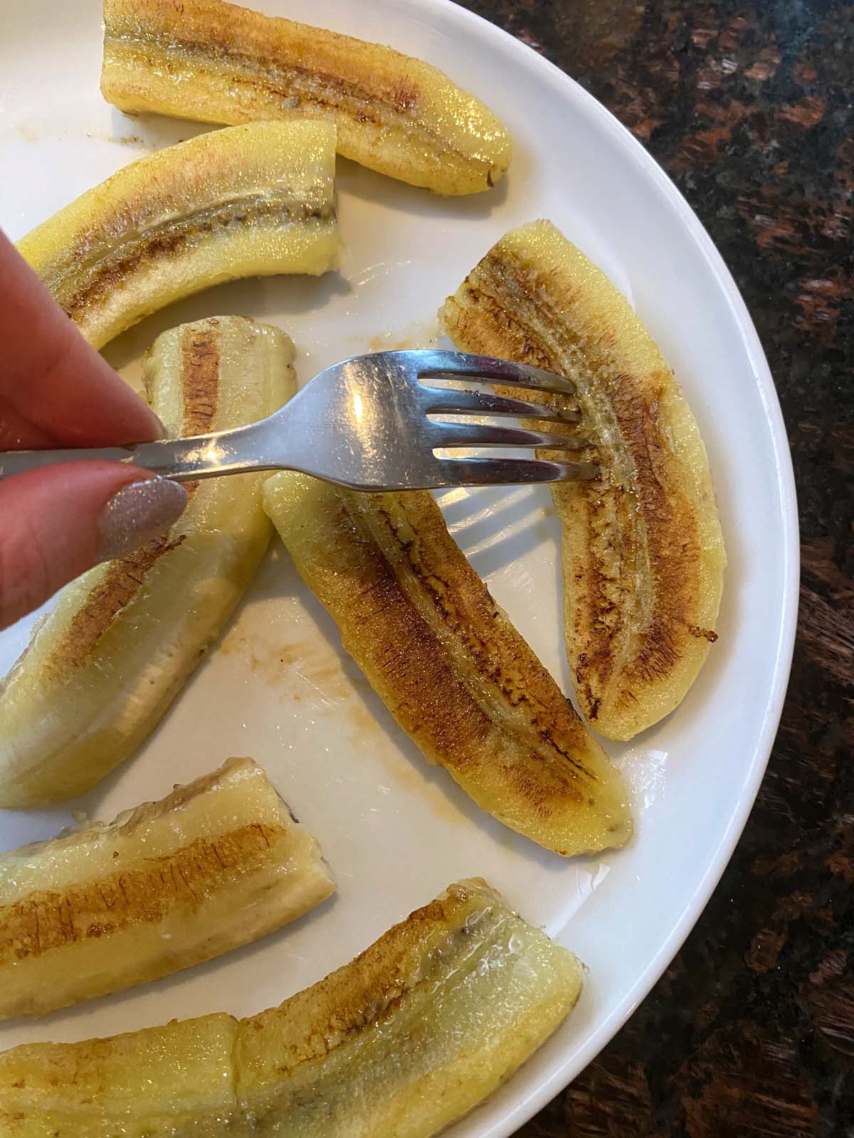 Fried bananas on a white plate.