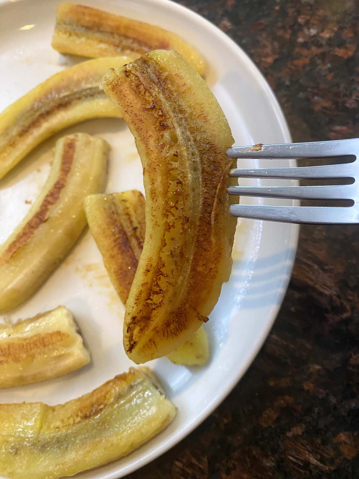 Fried bananas on a white plate.