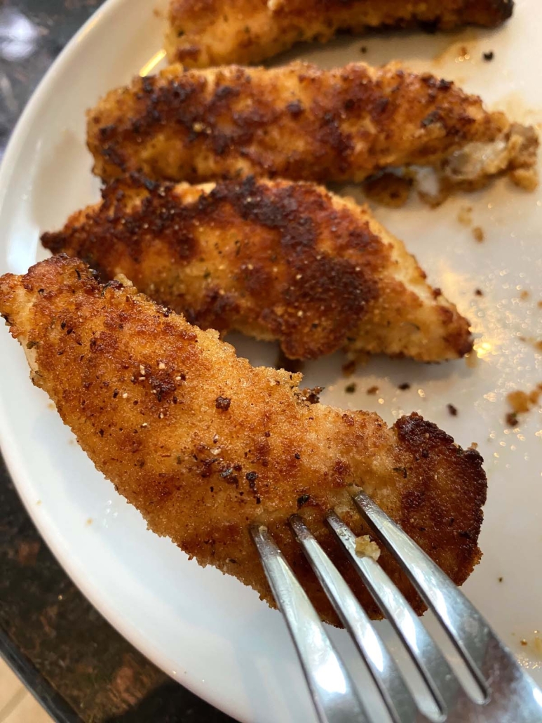 fork holding Pan Fried Breaded Chicken Tender