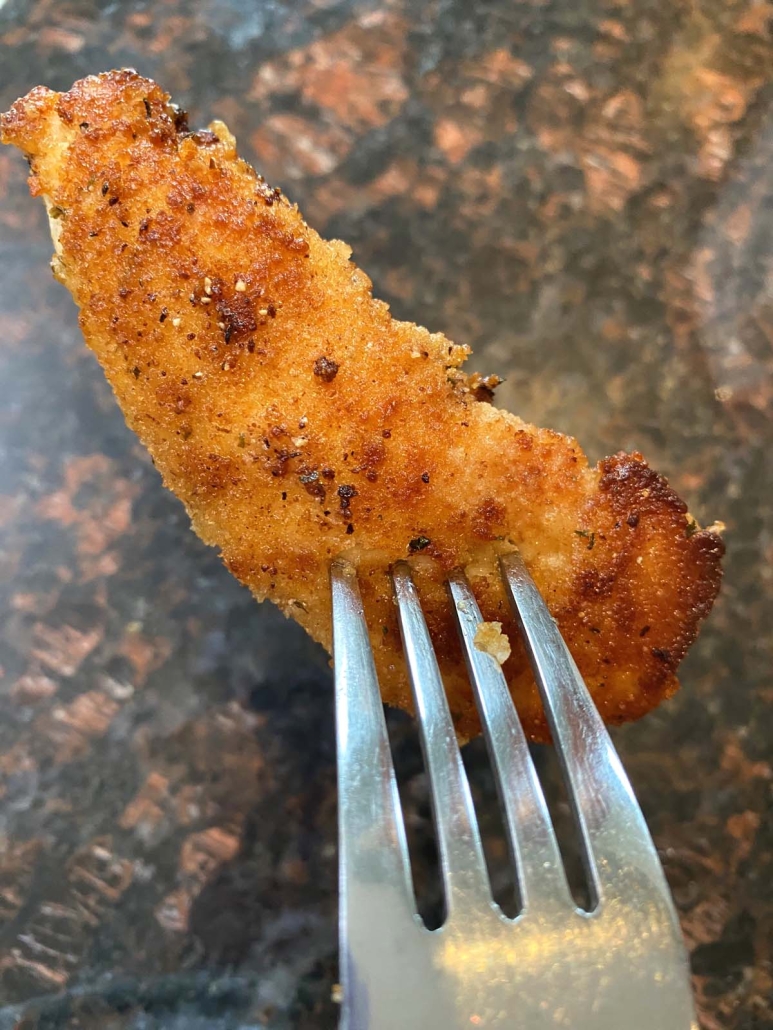 fork with one Pan Fried, Seasoned, Breaded Chicken Tender