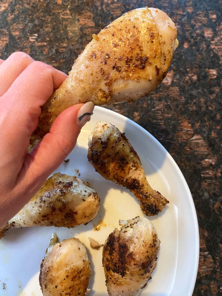 hand holding pan fried drumstick