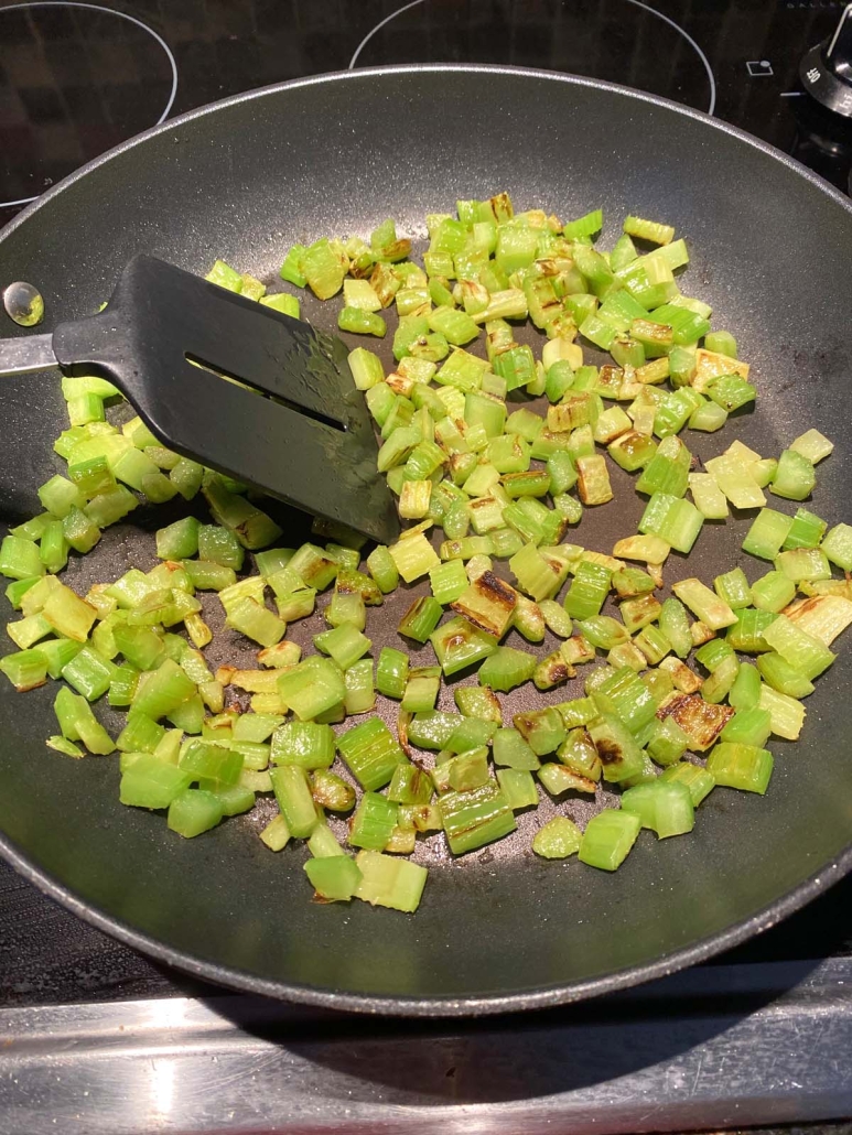 spatula mixing up seasoned Sauteed Celery