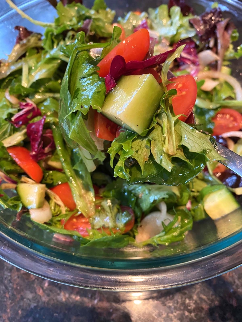 sliced cucumbers, tomatoes, and onion with Spring Mix Salad