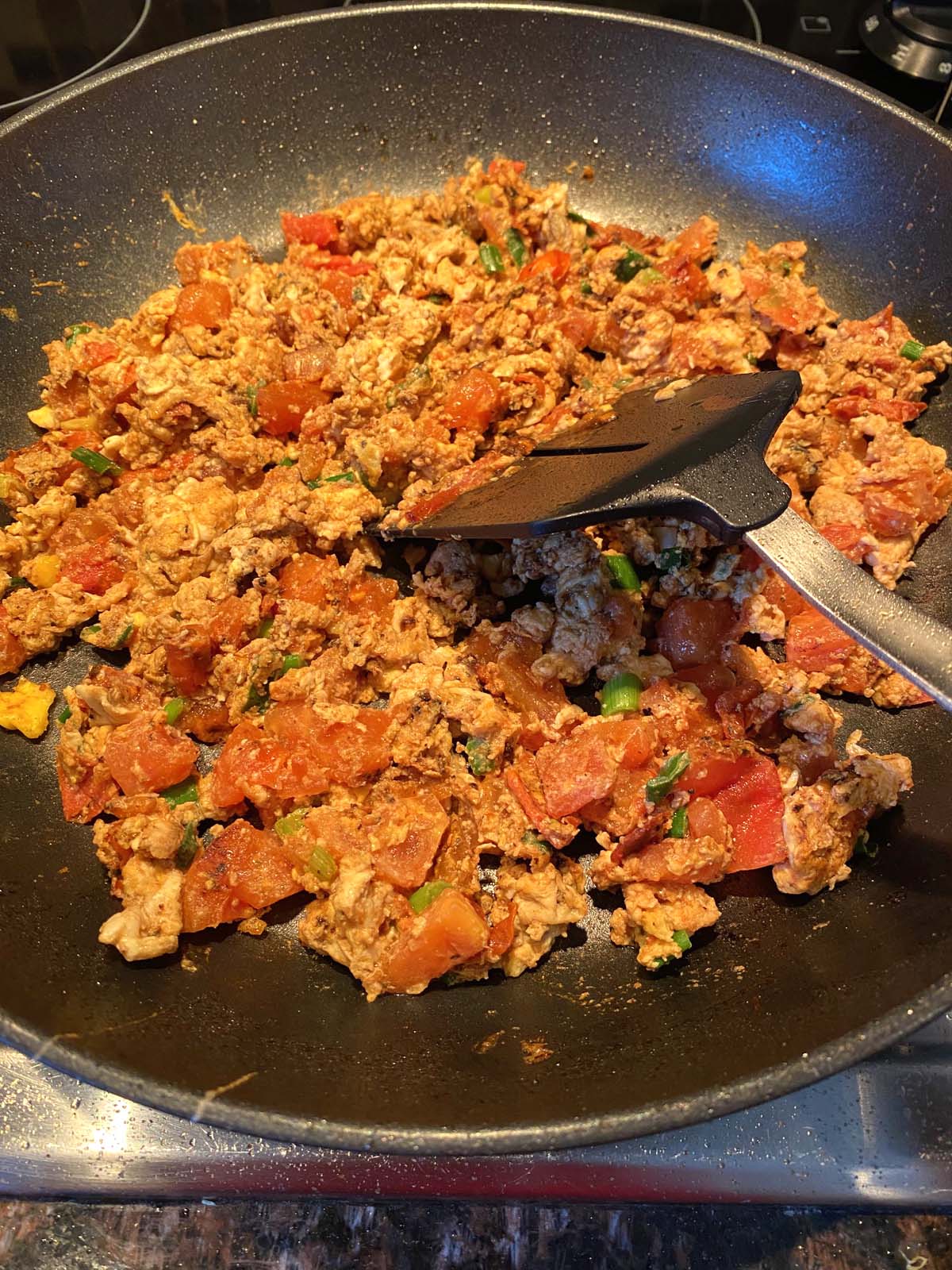 Chinese egg tomato stir fry in a skillet. 