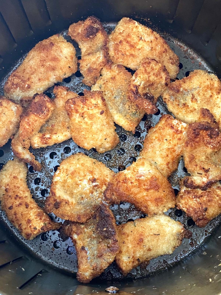 close-up of breaded catfish nuggets in air fryer basket