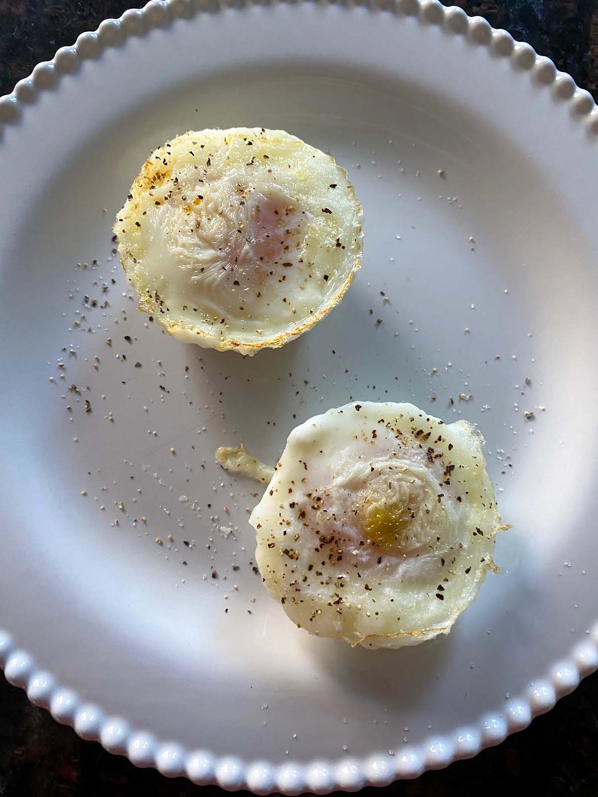 Air fryer poached eggs on a white plate.