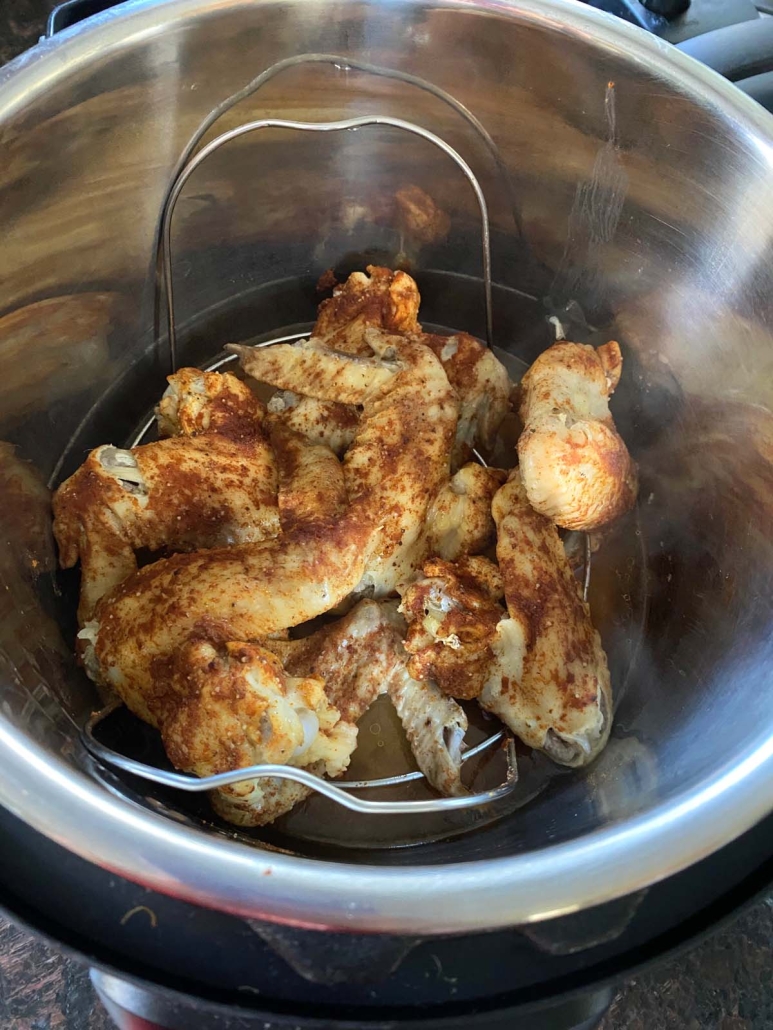 seasoned chicken wings cooking in the instant pot