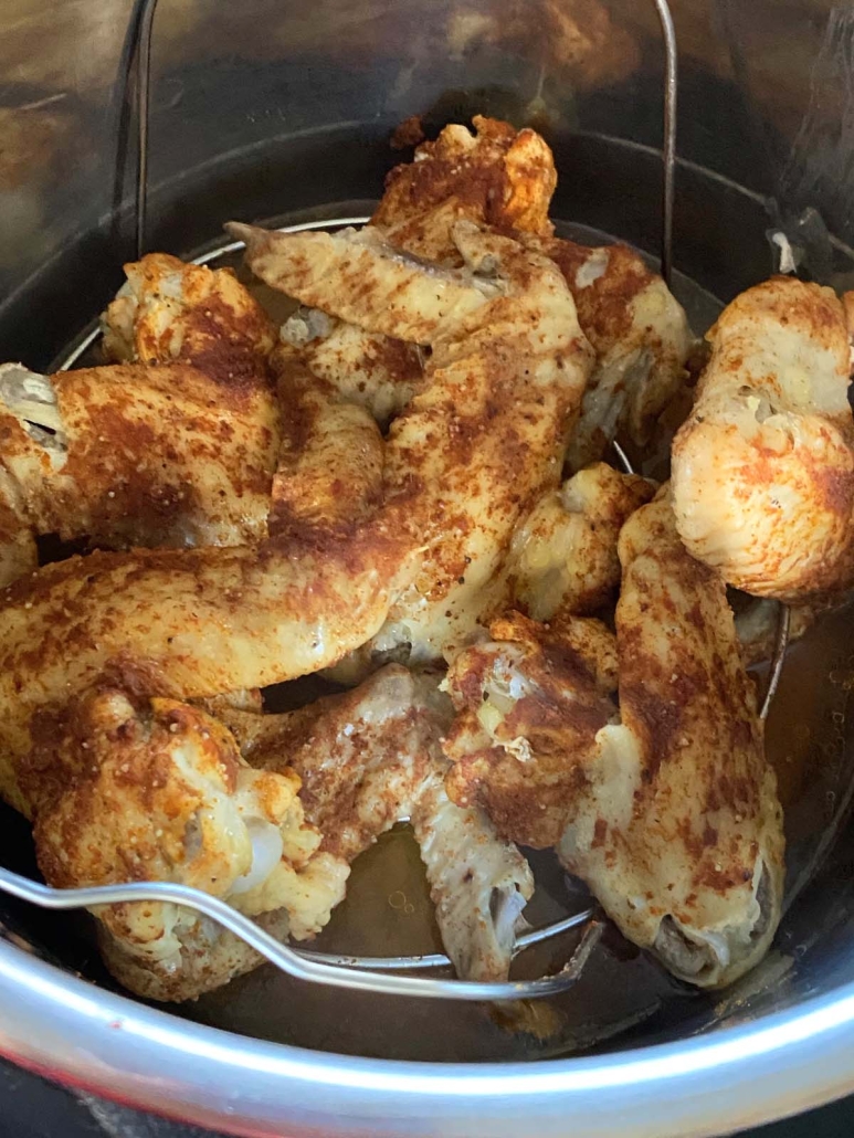 seasoned chicken wings on top of a trivet