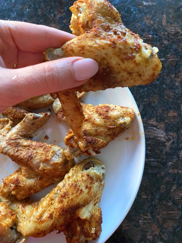 hand holding an Instant Pot Chicken Wing