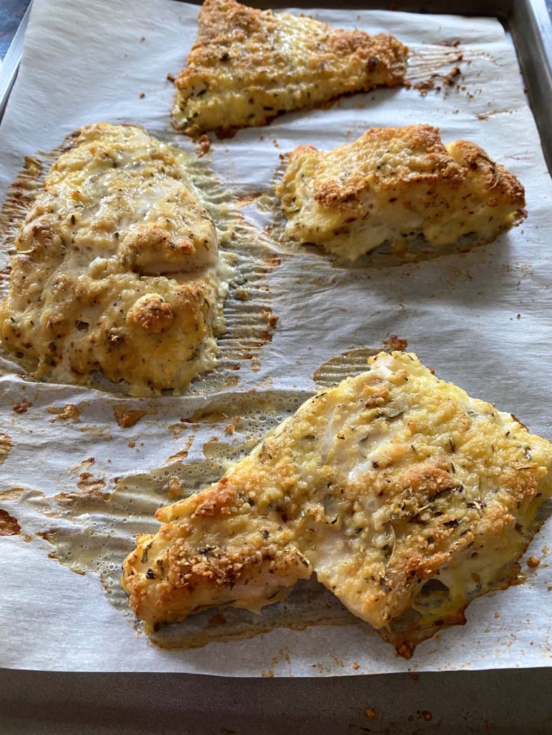 Parmesan Crusted Cod Fish fillets on a baking sheet