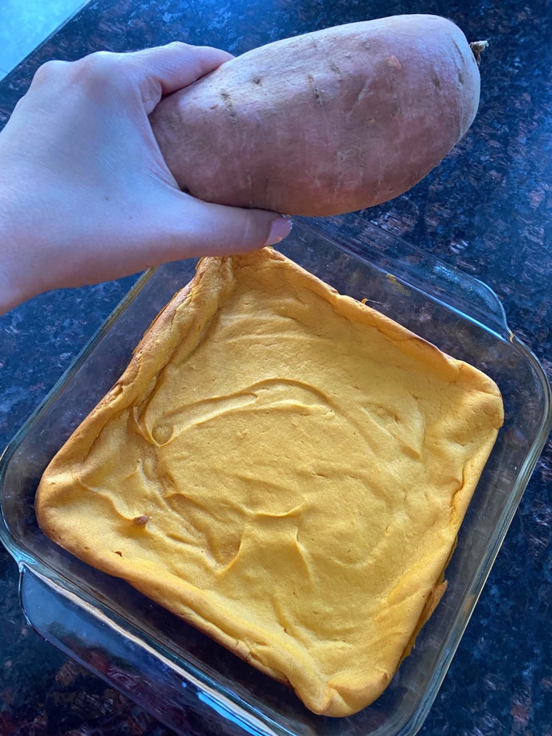 hand holding sweet potato by Sweet Potato Souffle