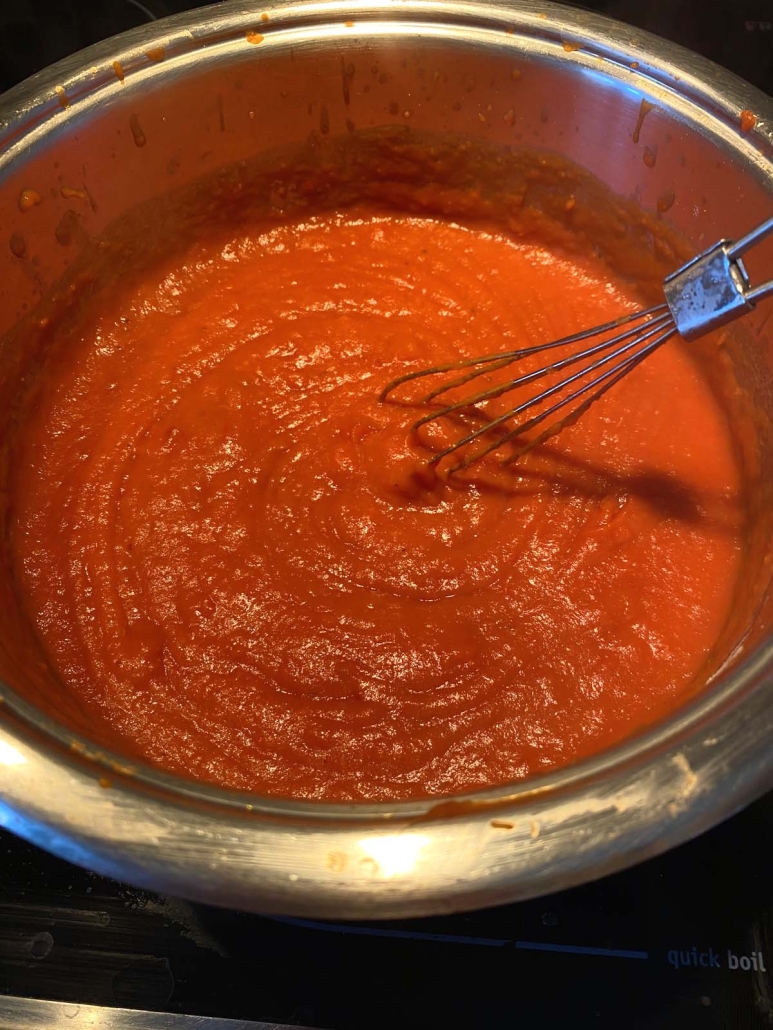 whisking up Tomato Gravy in stock pot