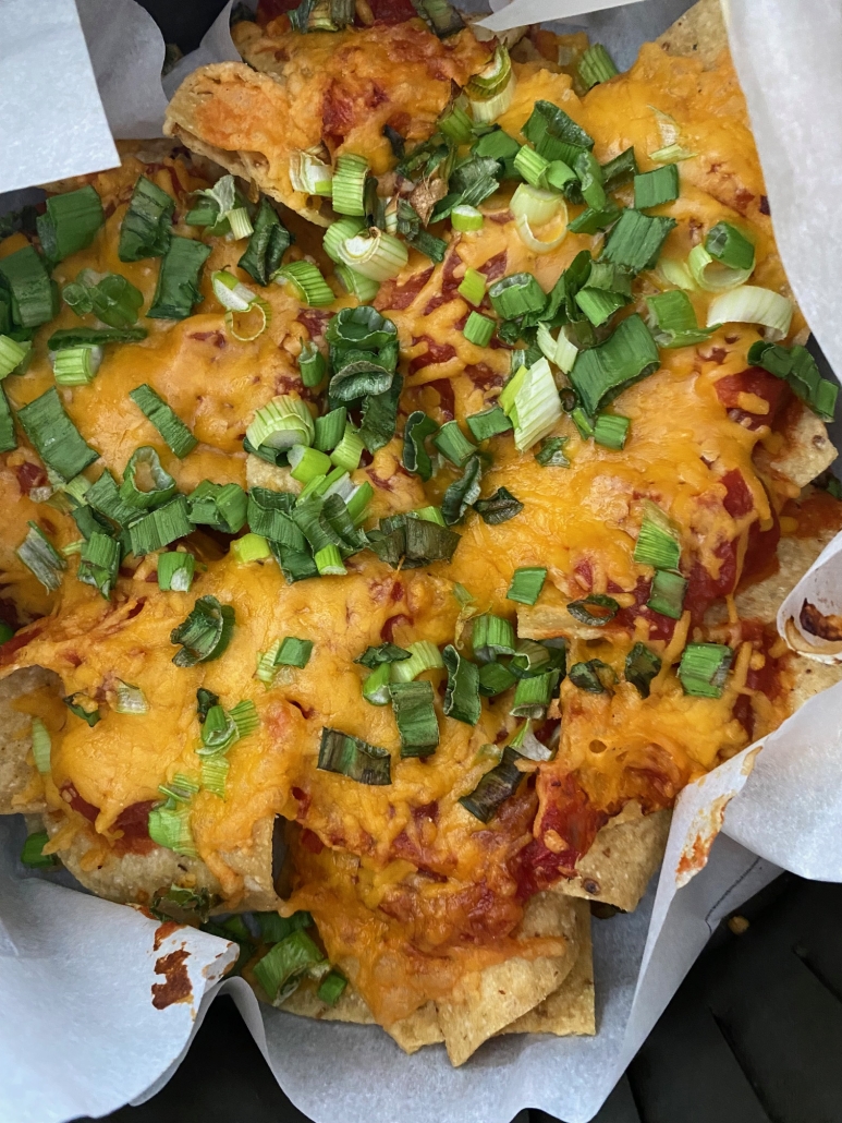 Air Fryer Nachos with shredded cheese, salsa, and green onions