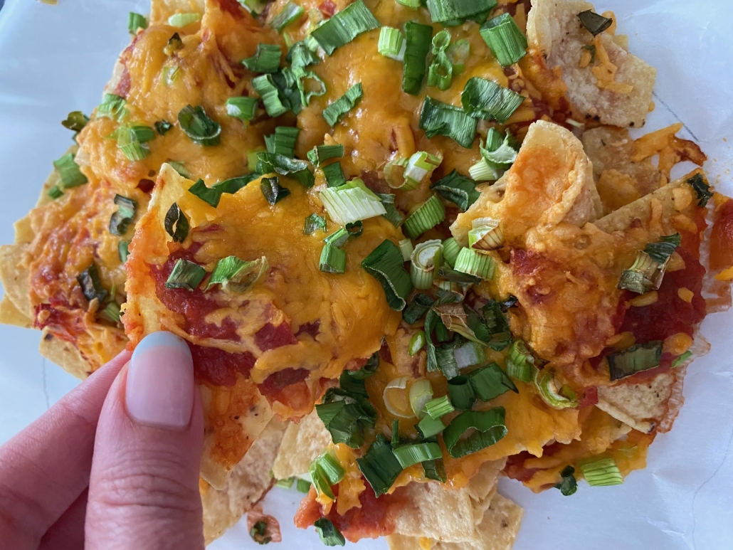 hand holding chip from Air Fryer Nachos