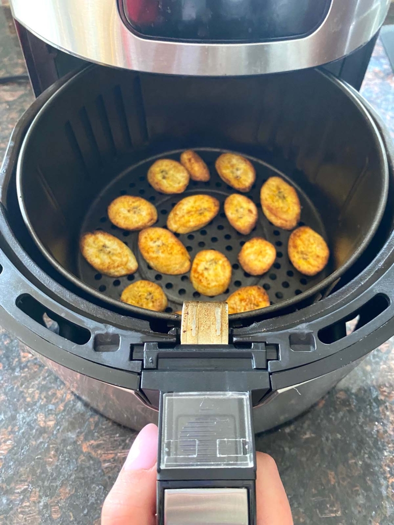 air fryer opened to show cooked plantains