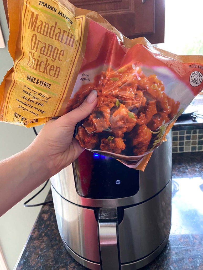 package of Trader Joe’s Orange Chicken next to air fryer