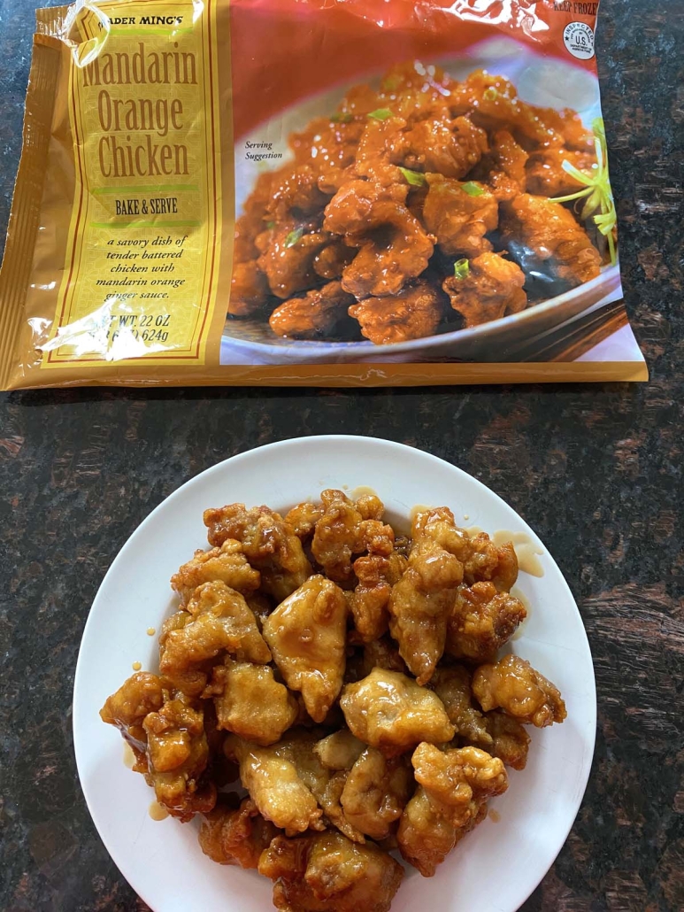 cooked Orange Chicken next to a package of Trader Joe’s Orange Chicken