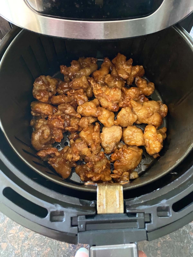 air fryer basket with Trader Joe’s Orange Chicken inside