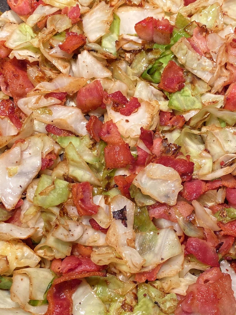 close-up of chopped cabbage and bacon fried in a skillet