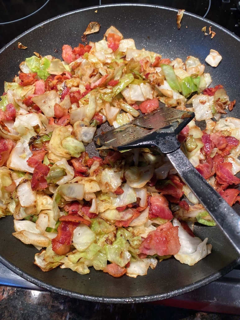 spatula moving around Fried Cabbage With Bacon