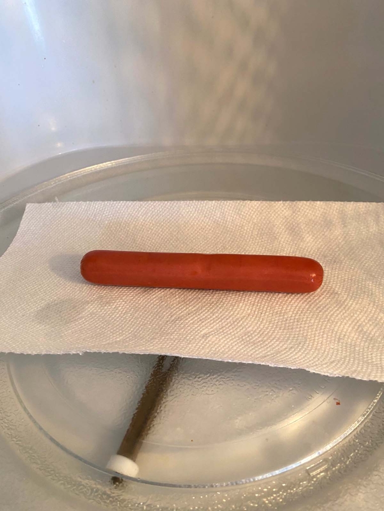 hot dog on a paper towel in the microwave