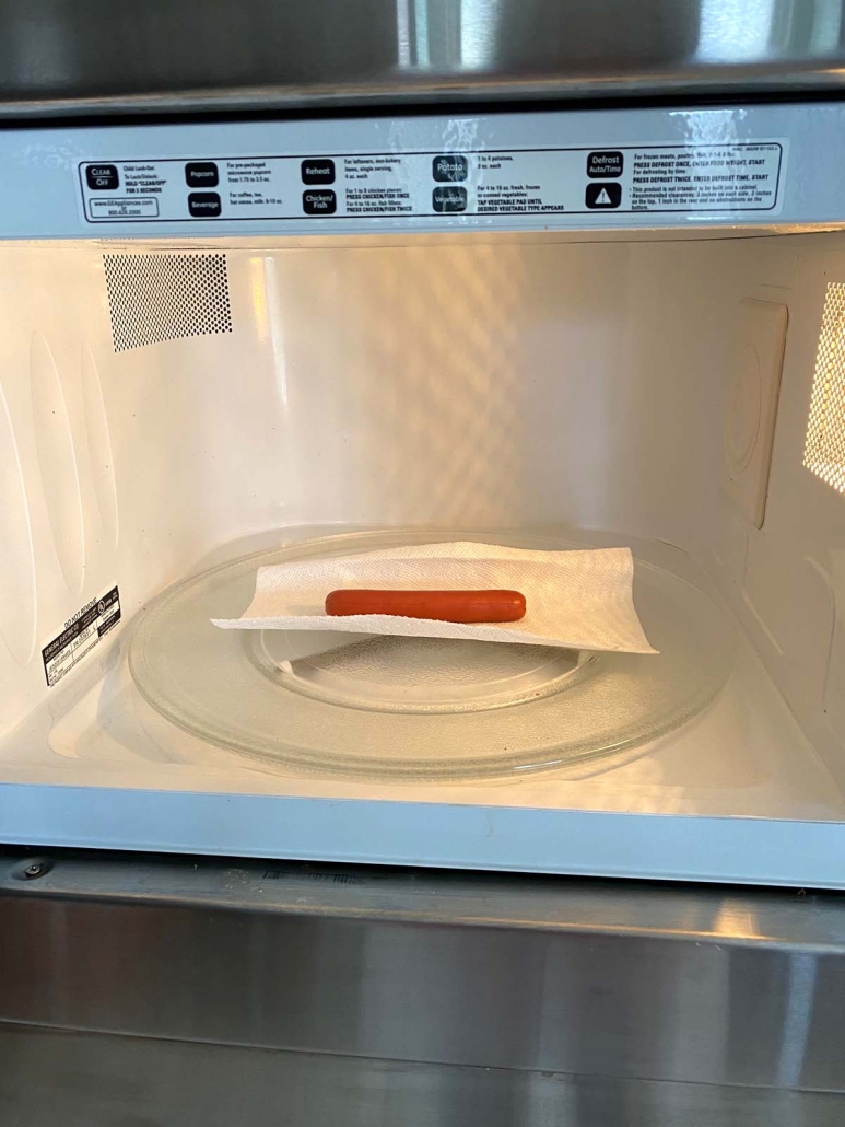 hot dog on paper towel after being heated in the microwave