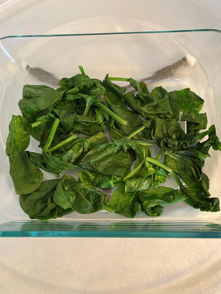 close-up view of steamed spinach in container