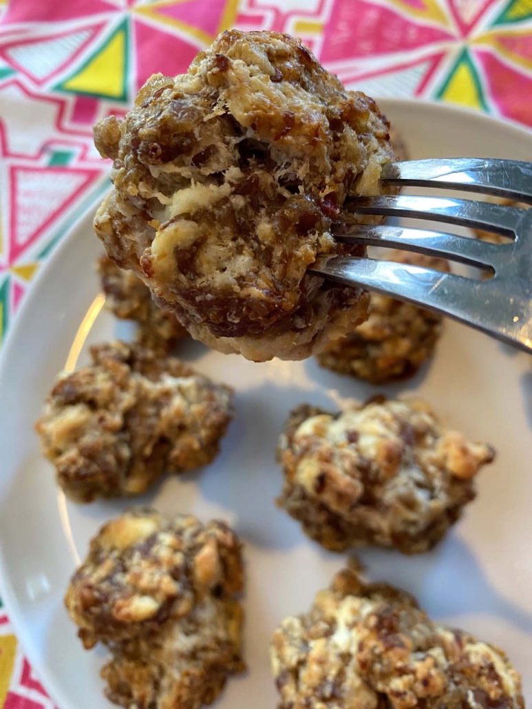 fork holding a piece of Sausage Balls With Cream Cheese