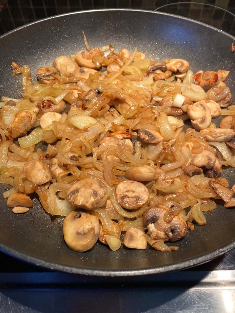 sautéing mushrooms and onions in a skillet