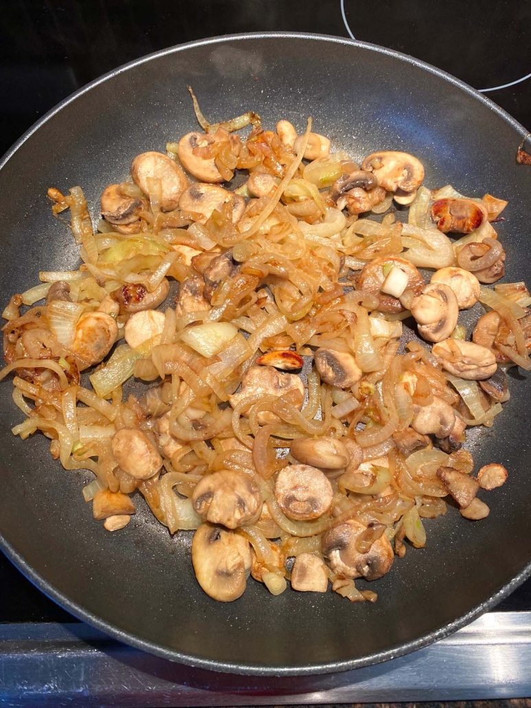 Sauteed Mushrooms And Onions in a nonstick frying pan