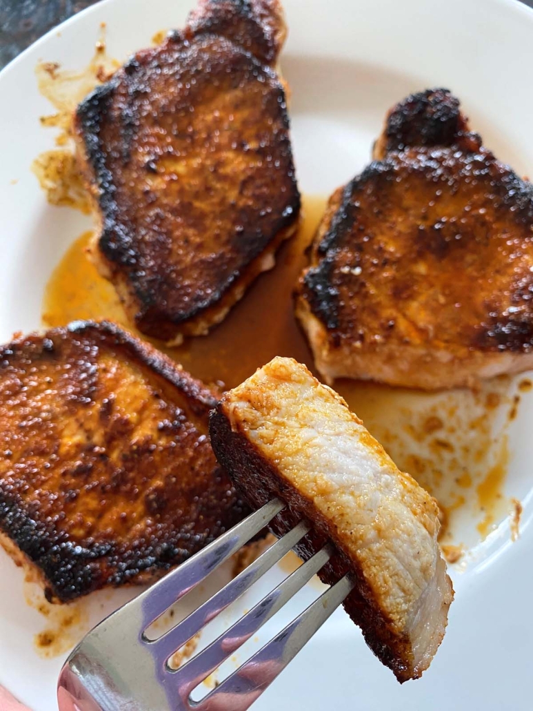 fork holding slice of Sauteed Pork Chop