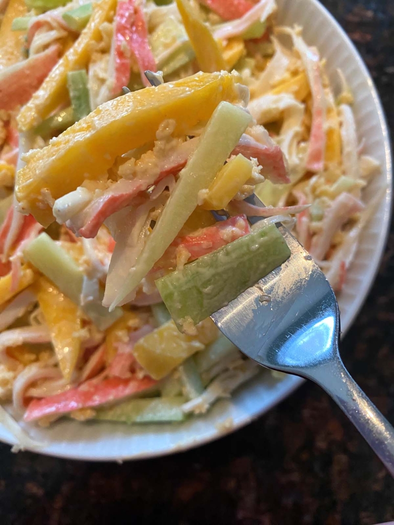 fork holding piece of crunchy Spicy Kani Salad