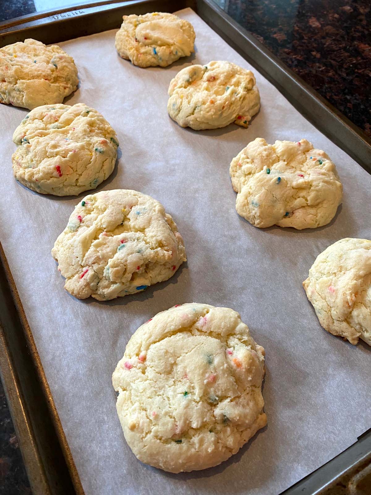 Funfetti cake mix cookies on a sheet pan.