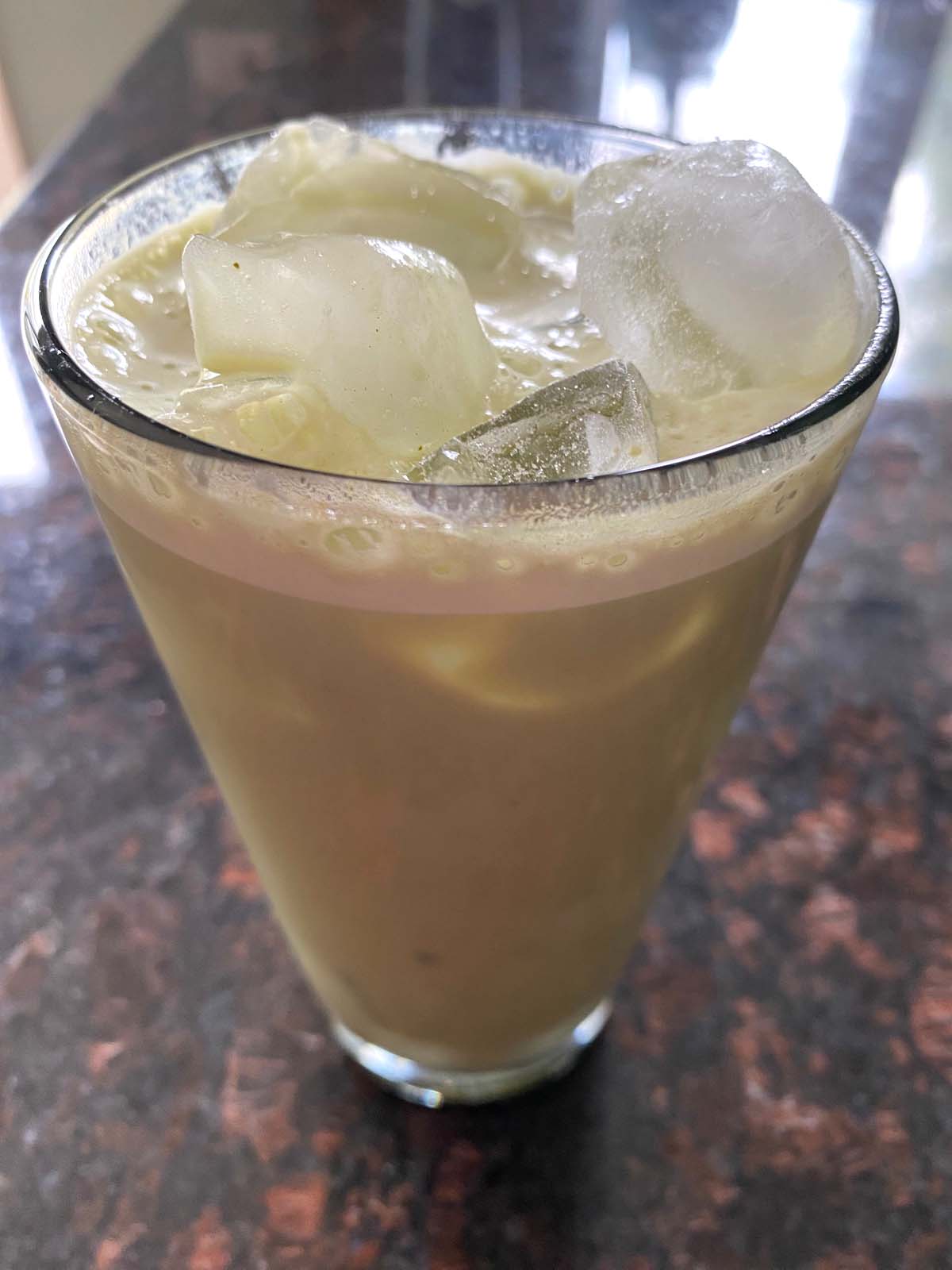 An iced matcha latte in a glass.