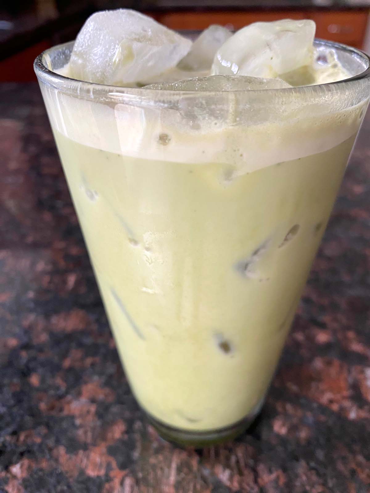 An iced matcha latte in a glass.