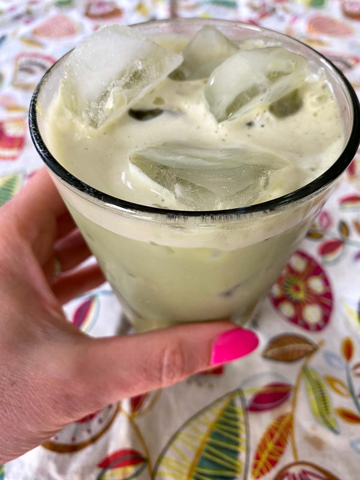 An iced matcha latte in a glass.