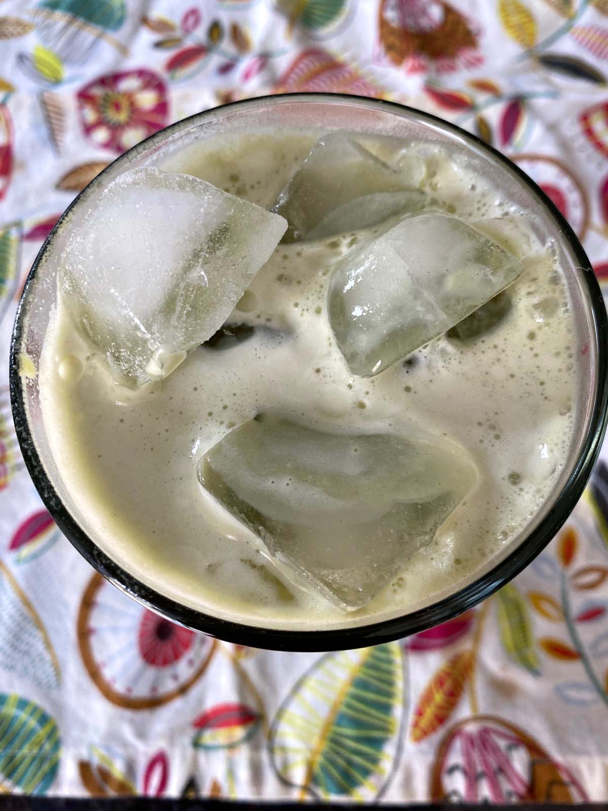 An iced matcha latte in a glass.