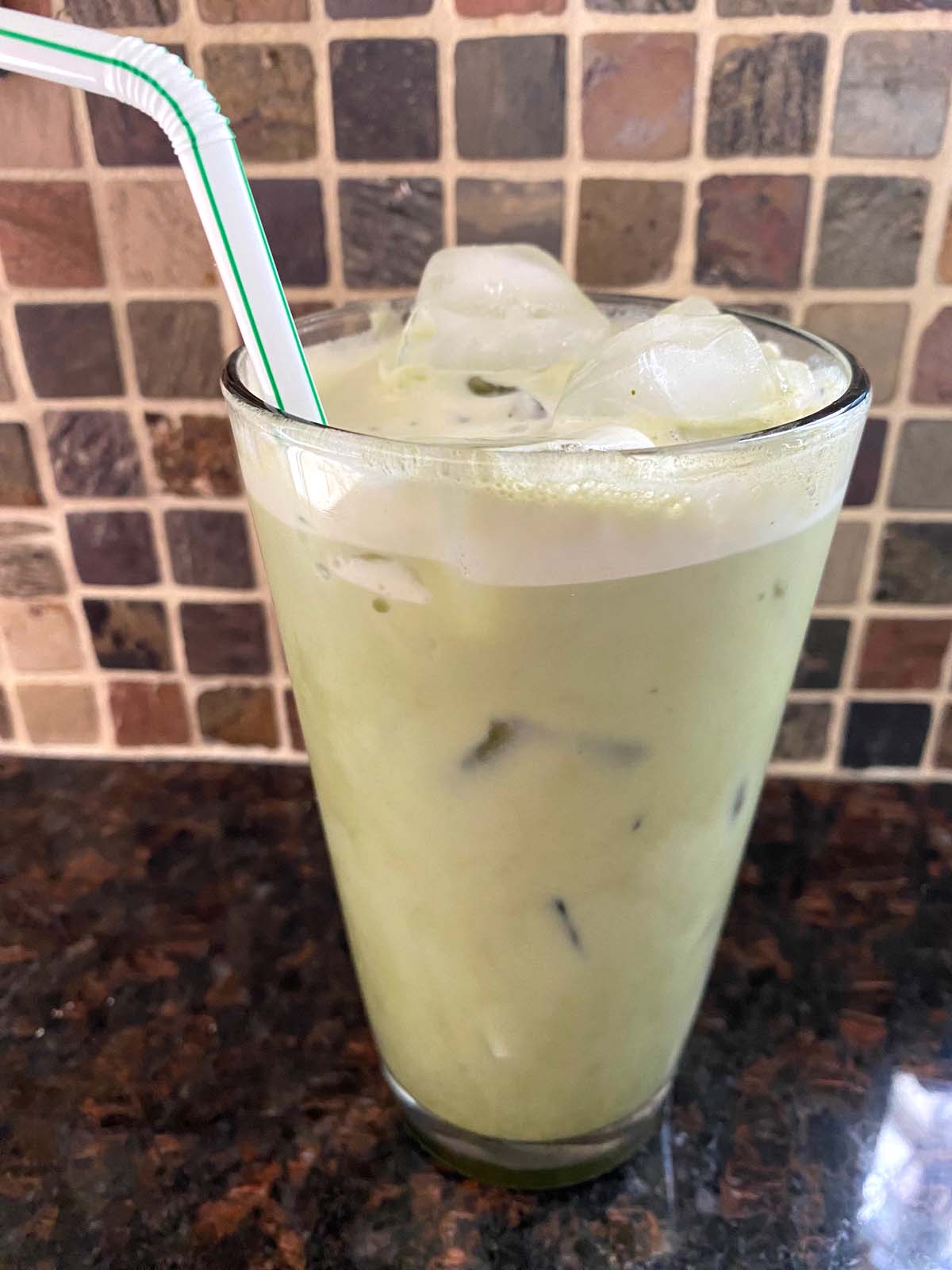 An iced matcha latte in a glass.