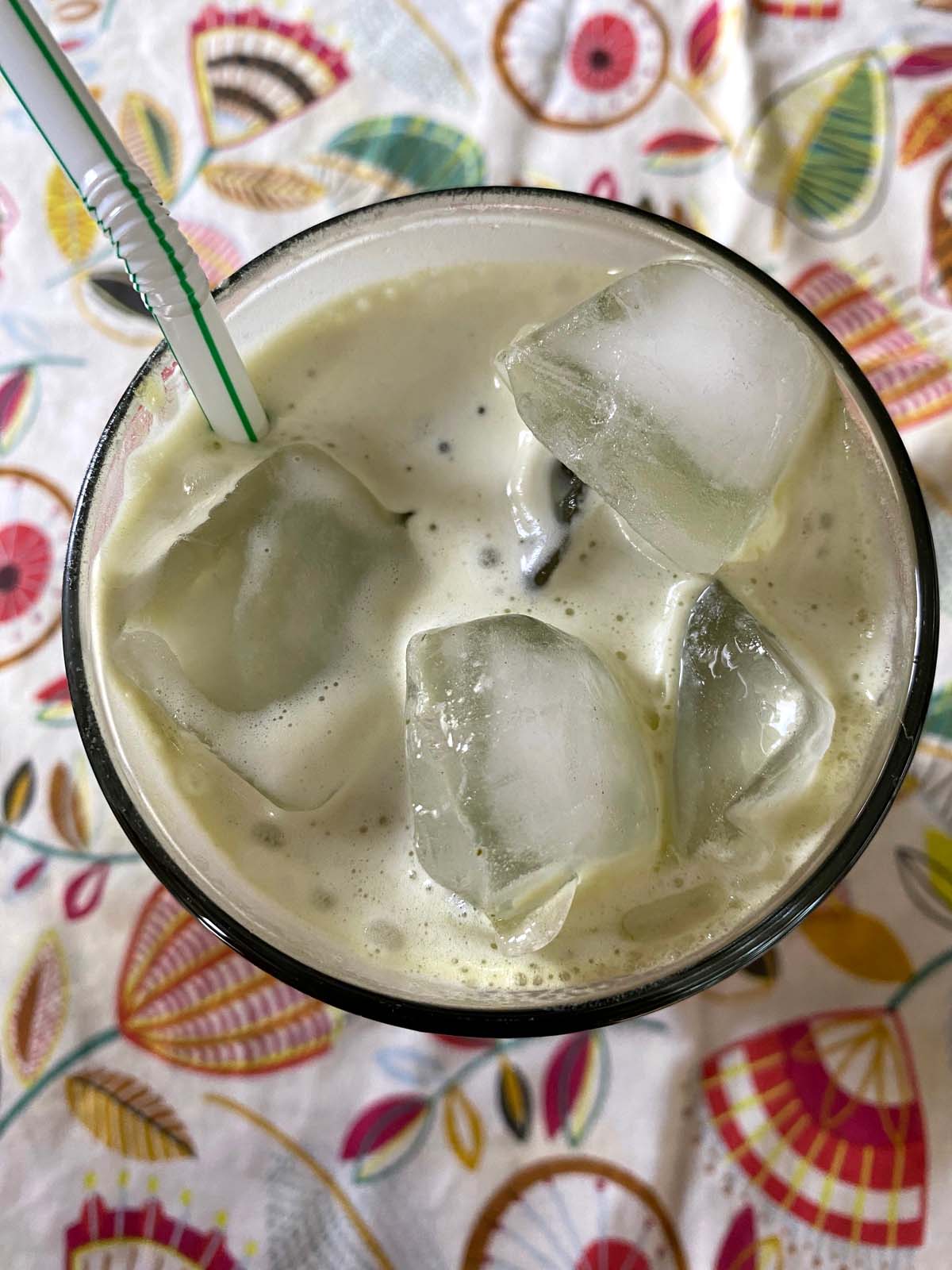 An iced matcha latte in a glass.