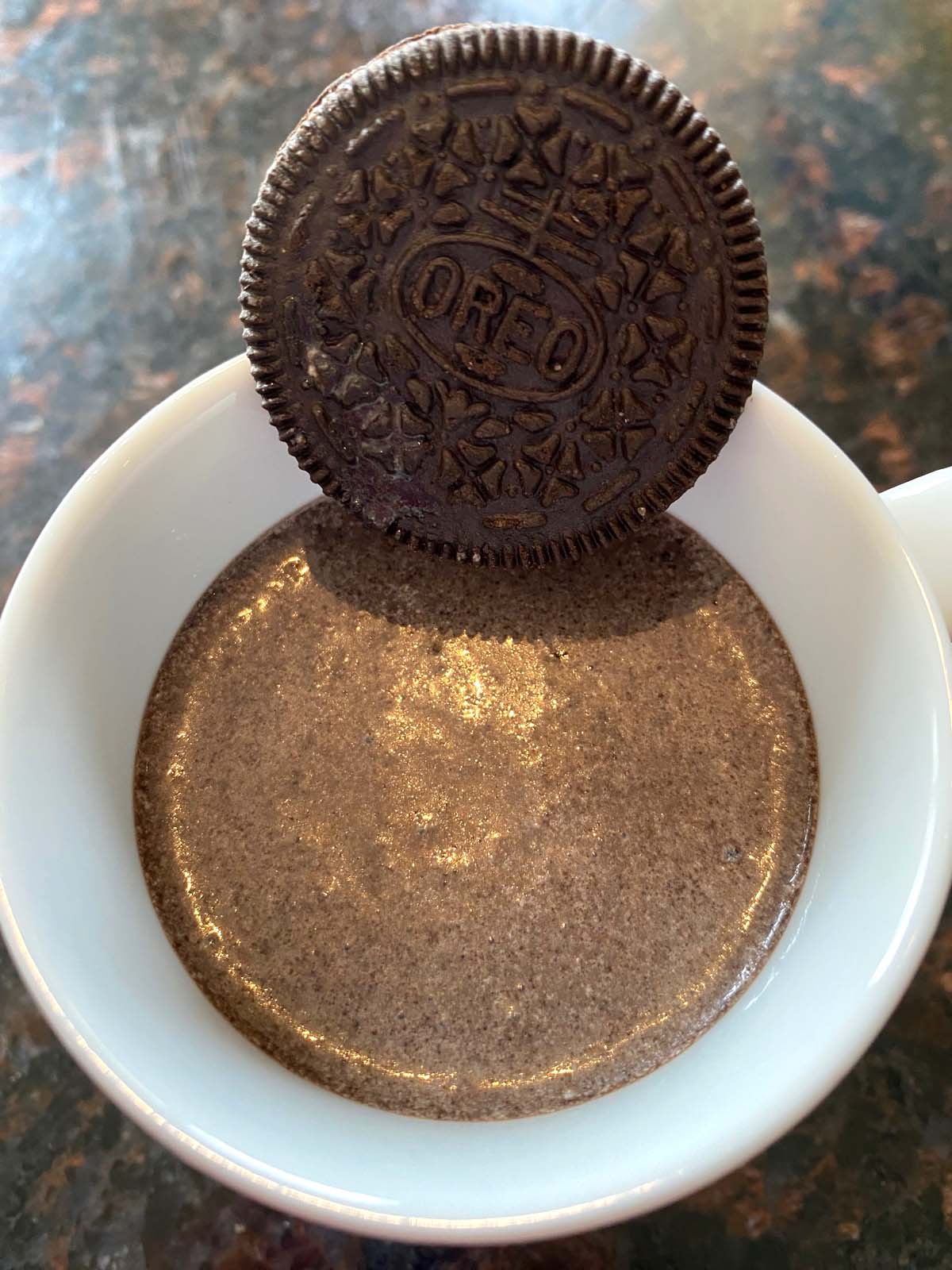 Oreo milkshake in a mug with an Oreo cookie.