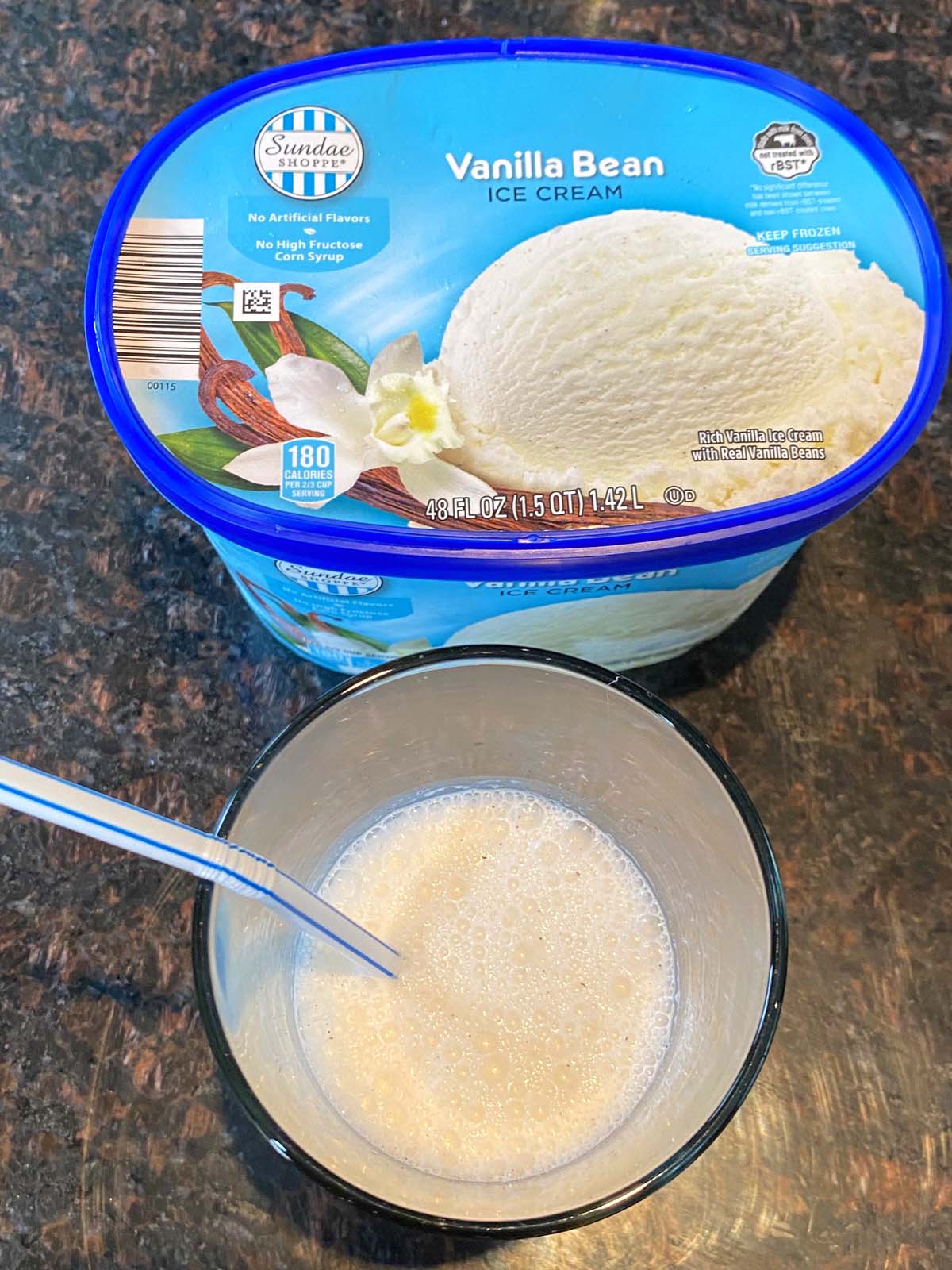 Vanilla milkshake with a tub of vanilla ice cream.
