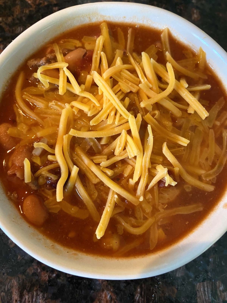 7 Can Taco Soup with shredded cheese on top