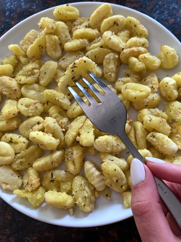 fork holding piece of Air Fryer Gnocchi