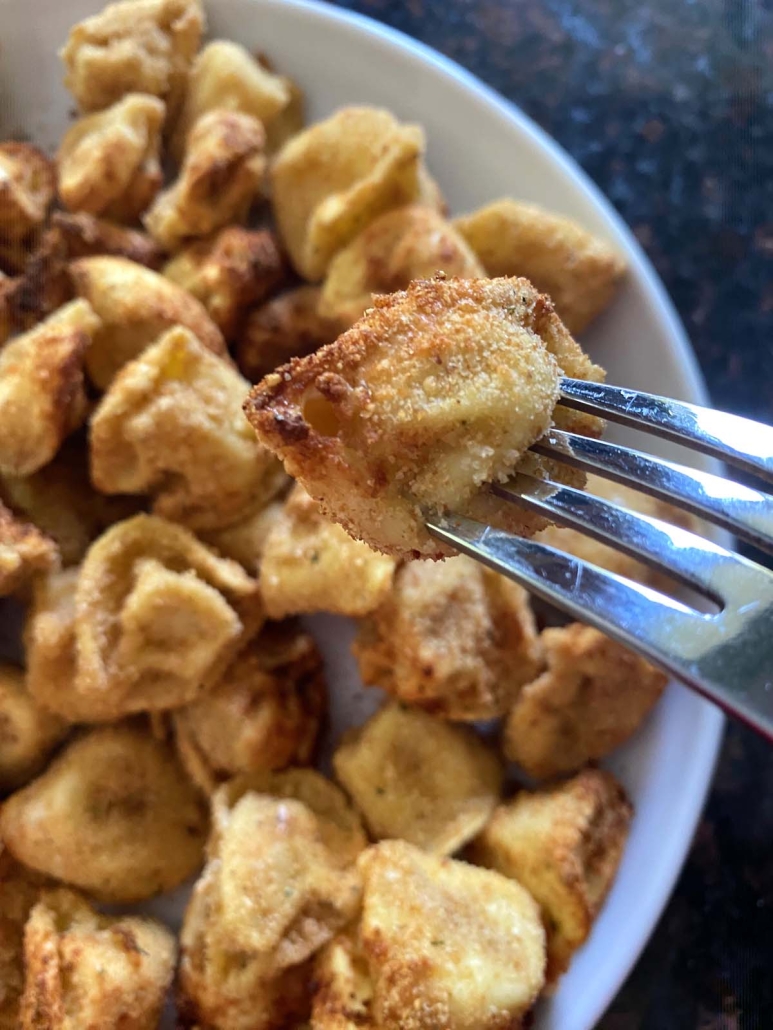 fork holding a piece of Air Fryer Tortellini