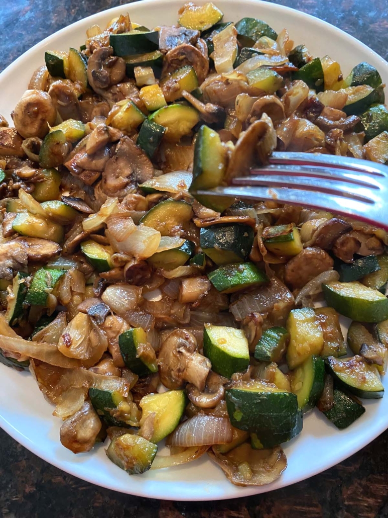 fork in vegetables cooked in a skillet